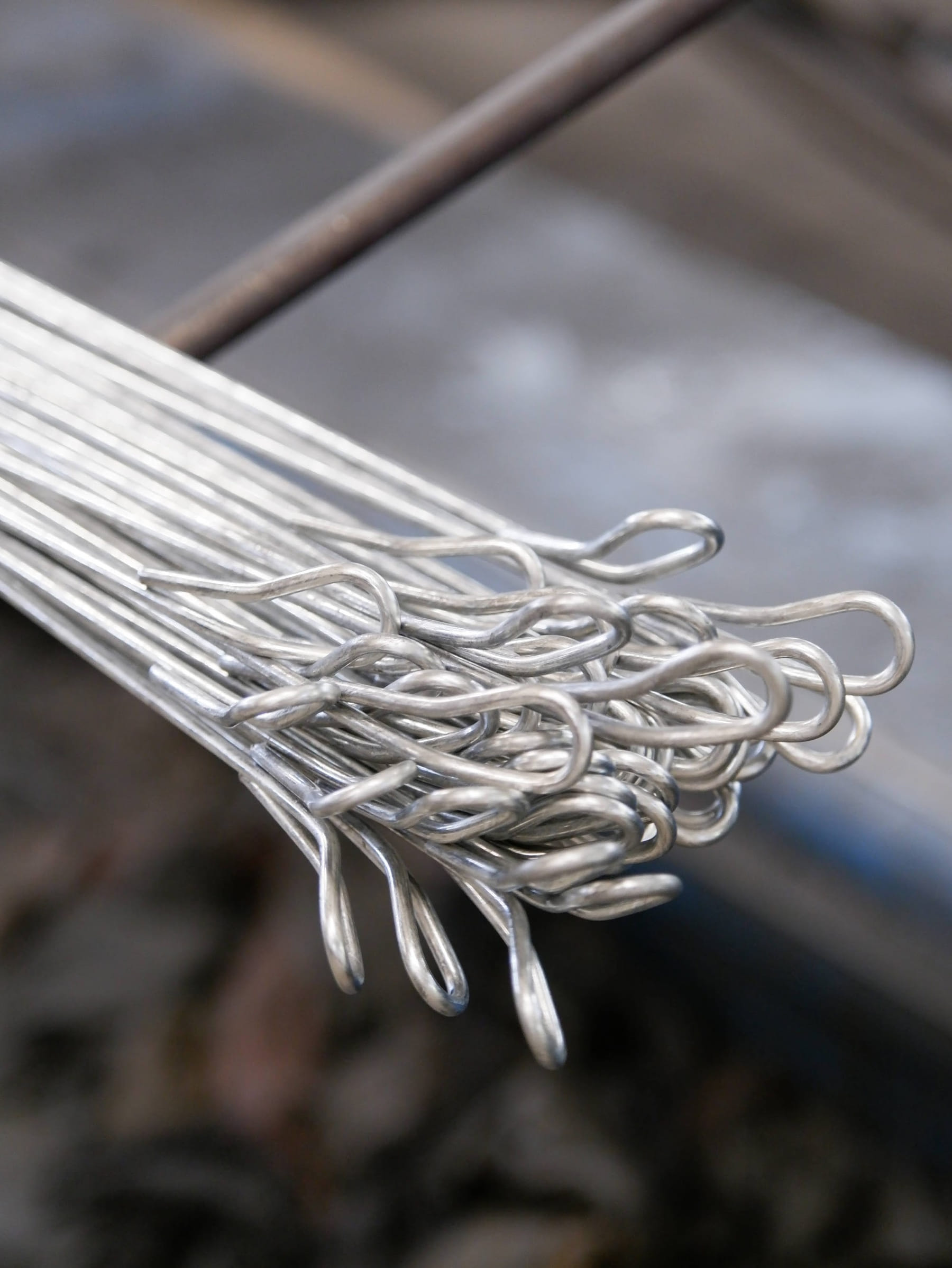 Bundle of looped bale ties held up, loop ends in focus