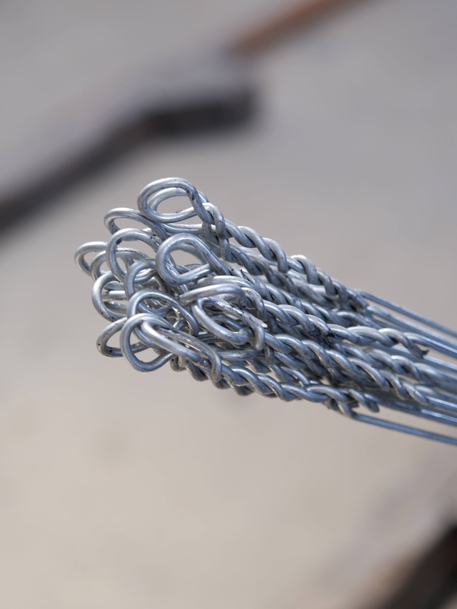 Bundle of double loop bale ties held up with the loop ends visible